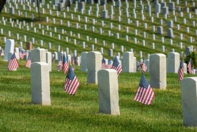 Headstones and flags on the hill at Arlington National Cemetery